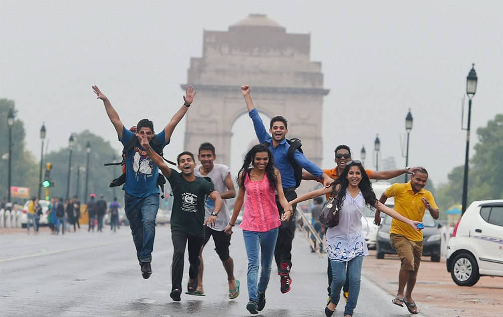 Youngsters enjoying the pre-monsoon showers at India Gate in New Delhi.