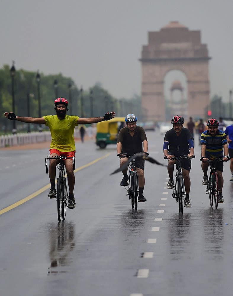 Cyclist at the Rajpath as the national capital received early morning showers in New Delhi.