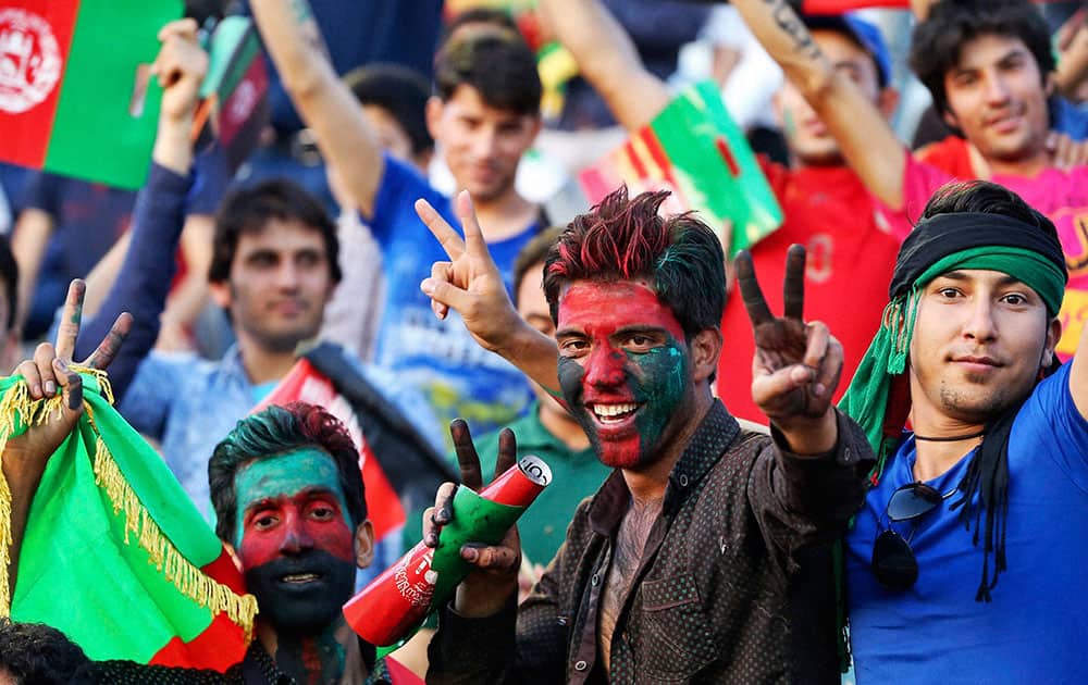 Afghanistan soccer fans show the victory sign during a match between Afghanistan and Syria at FIFA World Cup 2018 qualifiers in Mashhad, Iran.