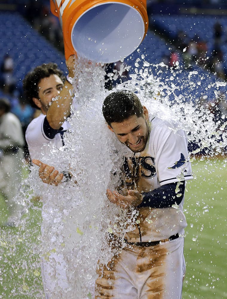 Tampa Bay Rays' Kevin Kiermaier, right, gets doused with water by David DeJesus after the Rays defeated the Washington Nationals 6-1 during a baseball game, in St. Petersburg, Fla.