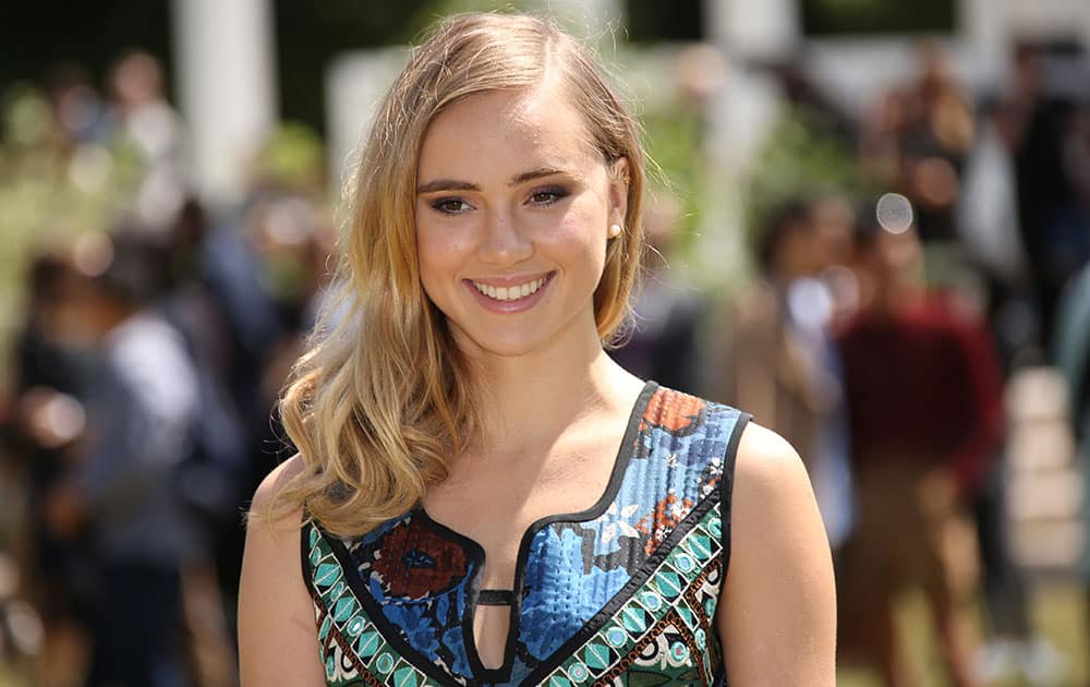 Suki Waterhouse poses for photographers upon arrival at the Burberry Prorsum menswear Spring Summer fashion show in London.