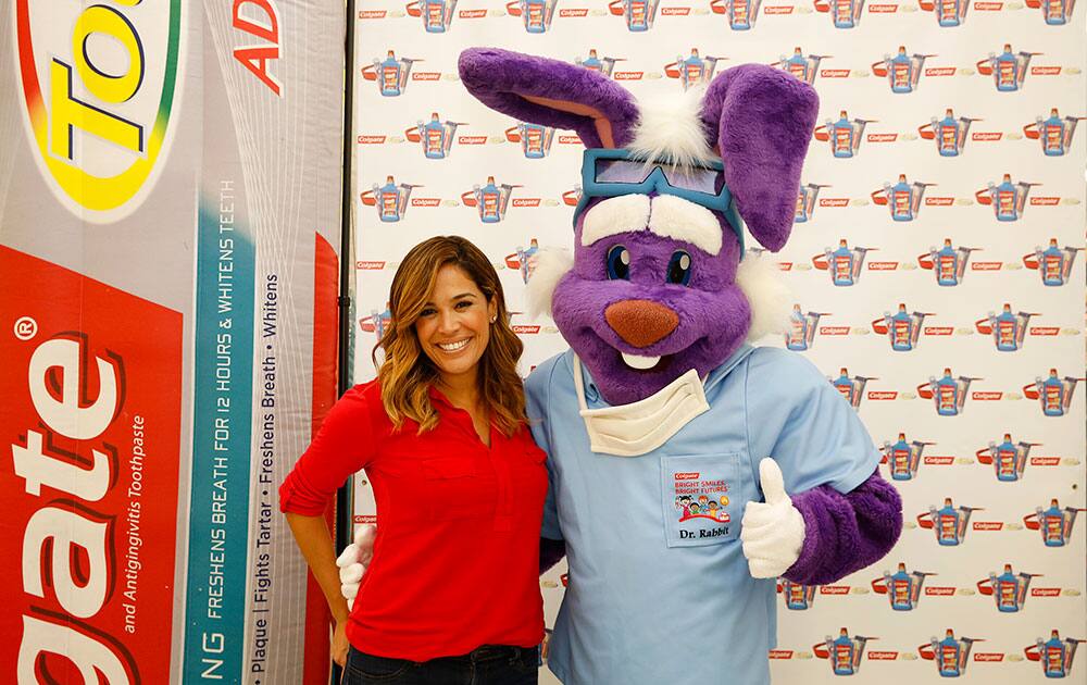 Karla Martinez speaks to children about the importance of dental care as part of Colgate's Oral Health Month,  at Fiesta Mart in Houston.