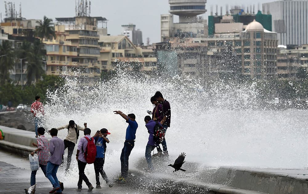 Mumbaikars enjoy high tide during a monsoon season in Mumbai.