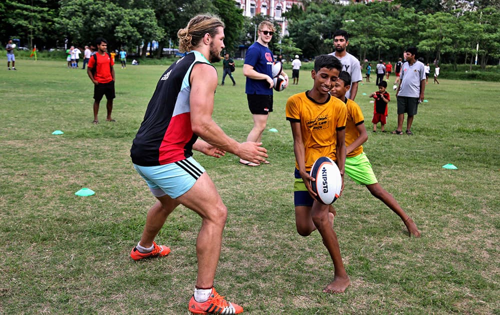 Luke Wallace of Harlequins Football Club of England plays rugby with underprivileged Indian children at a coaching camp in Kolkata.