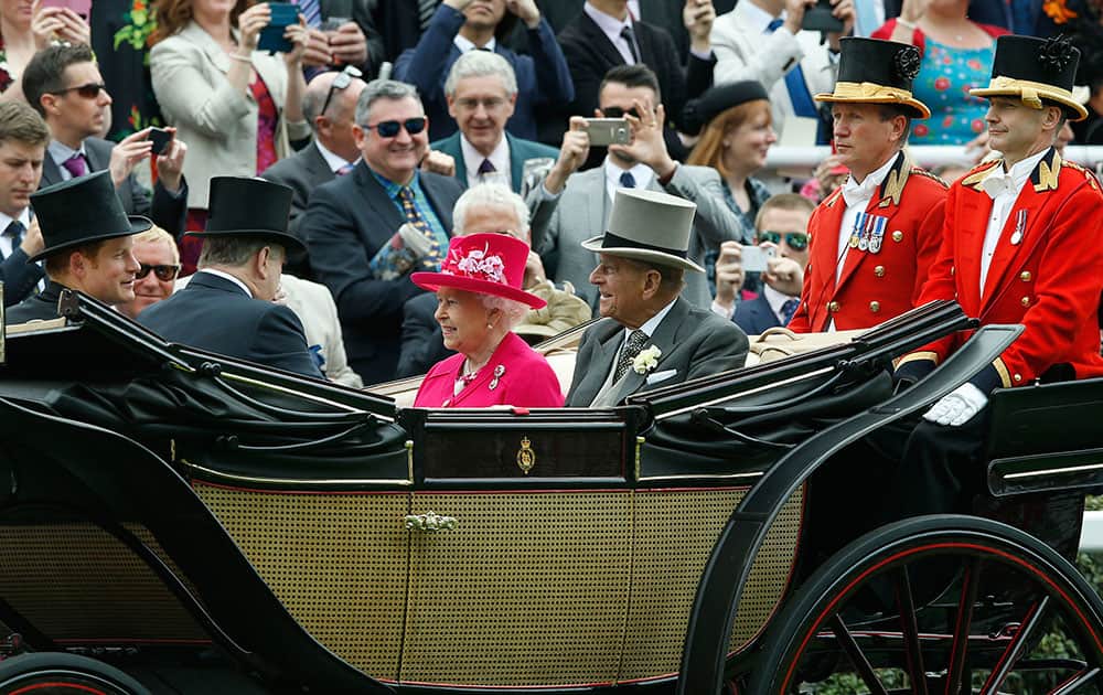 Britain's Queen Elizabeth II arrives with Prince Philip, the Duke of Edinburgh and Prince Harry for the first day of Royal Ascot horse racing meet at Ascot, England.