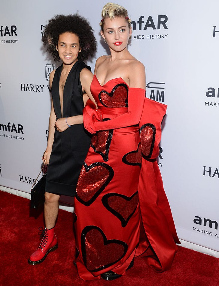 Honoree Miley Cyrus, right, arrives with friend Tyler Ford at the 6th Annual amfAR New York Inspiration Gala at Spring Studios in New York.