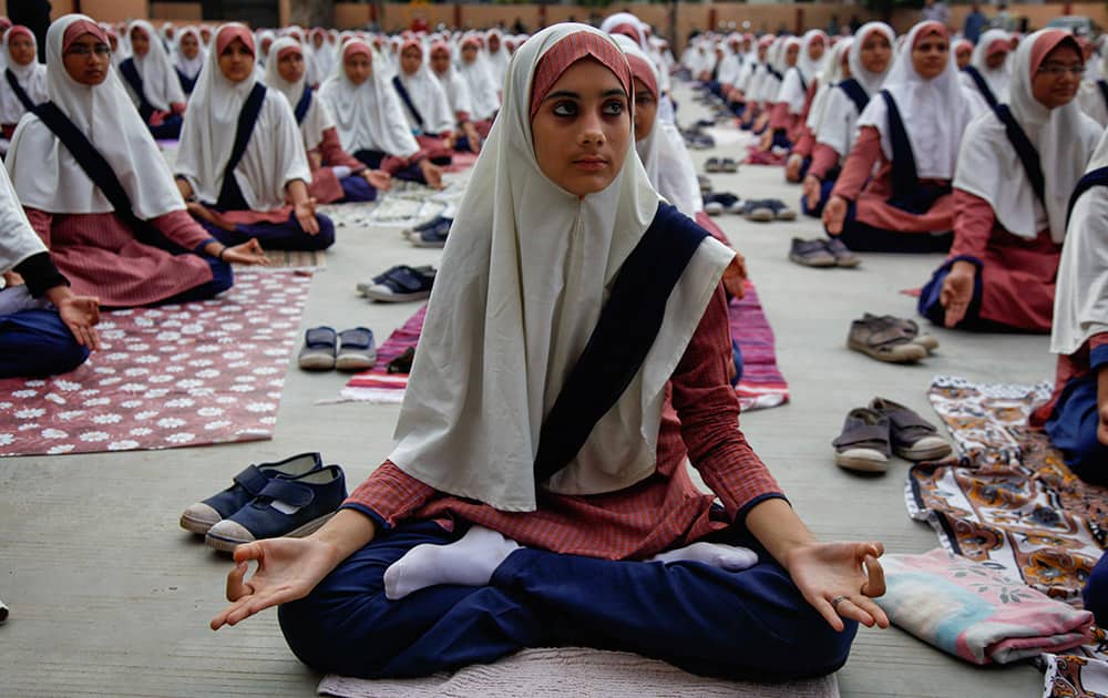 Muslim students practice yoga at a school ahead of first International Yoga Day in Ahmedabad.