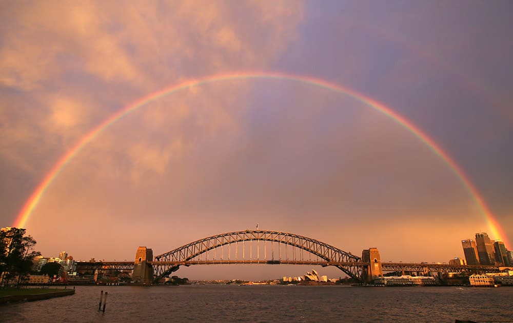A rainbow forms over the Harbour Bridge on a wet day in Sydney.