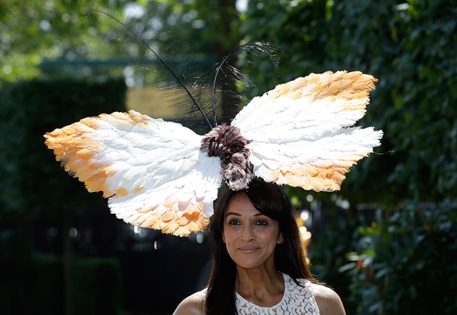 Jackie St Clair poses for photographers as she arrives for the first day of Royal Ascot horse racing meet at Ascot, England.