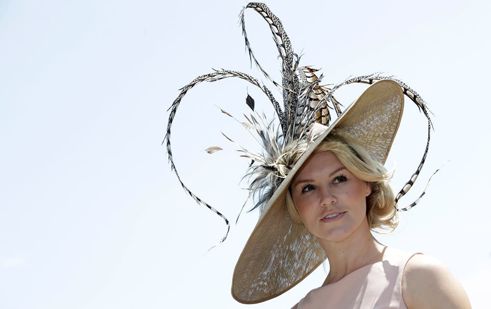 Amy Guy poses for photographers on the first day of Royal Ascot horse racing meet at Ascot, England.