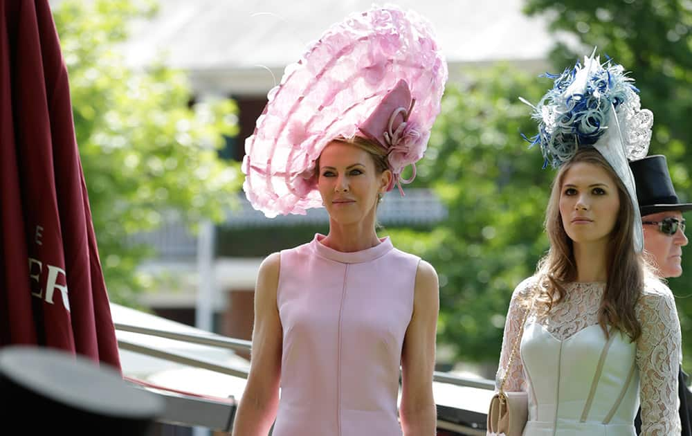 Belinda Studwick with her daughter Alexandra wait for TV interview on the first day of Royal Ascot horse racing meet at Ascot, England.