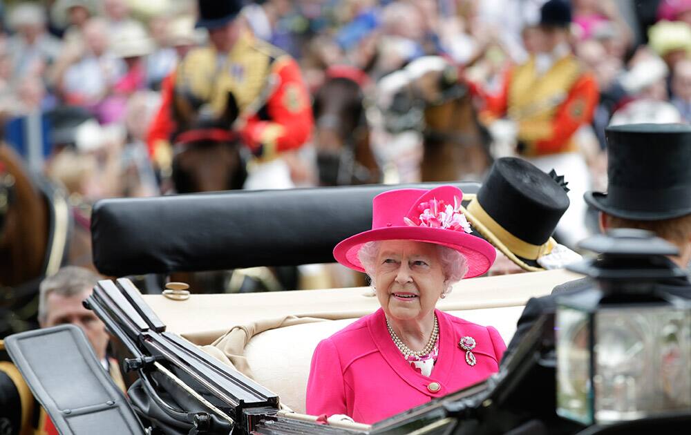 Britain's Queen Elizabeth II looks at the crowds around the Parade ring as she arrive on the first day of Royal Ascot horse racing meet at Ascot, England.