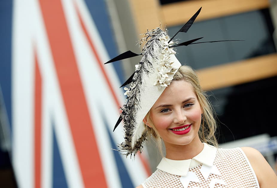 Eleanor Matthews poses for photographers as she arrives for the second day of Royal Ascot horse racing meet at Ascot, England.