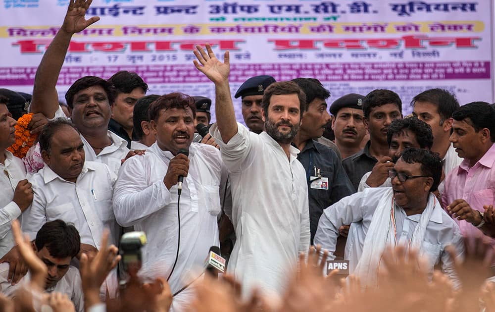 Congress party Vice President Rahul Gandhi waves as he leaves after addressing a protest by sanitation workers in New Delhi. Hundreds of sanitation workers gathered near the Indian parliament for a protest demanding the payment of wages due to them.