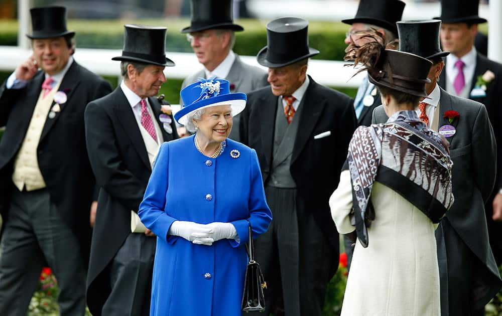 Britain's Queen Elizabeth II smiles as she walks in the paddock on the second day of Royal Ascot horse racing meet at Ascot, England.