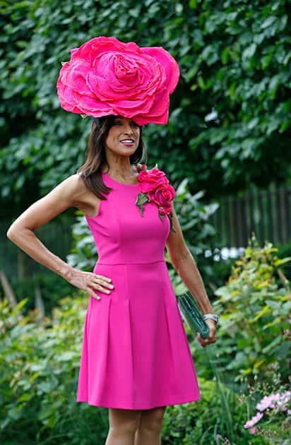 A race goer poses for photographers on the second day of Royal Ascot horse racing meet at Ascot, England.