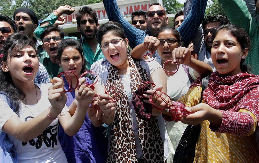 Student show bangles at a protest against the governments decision to give AIIMS to Kashmir, in Jammu.
