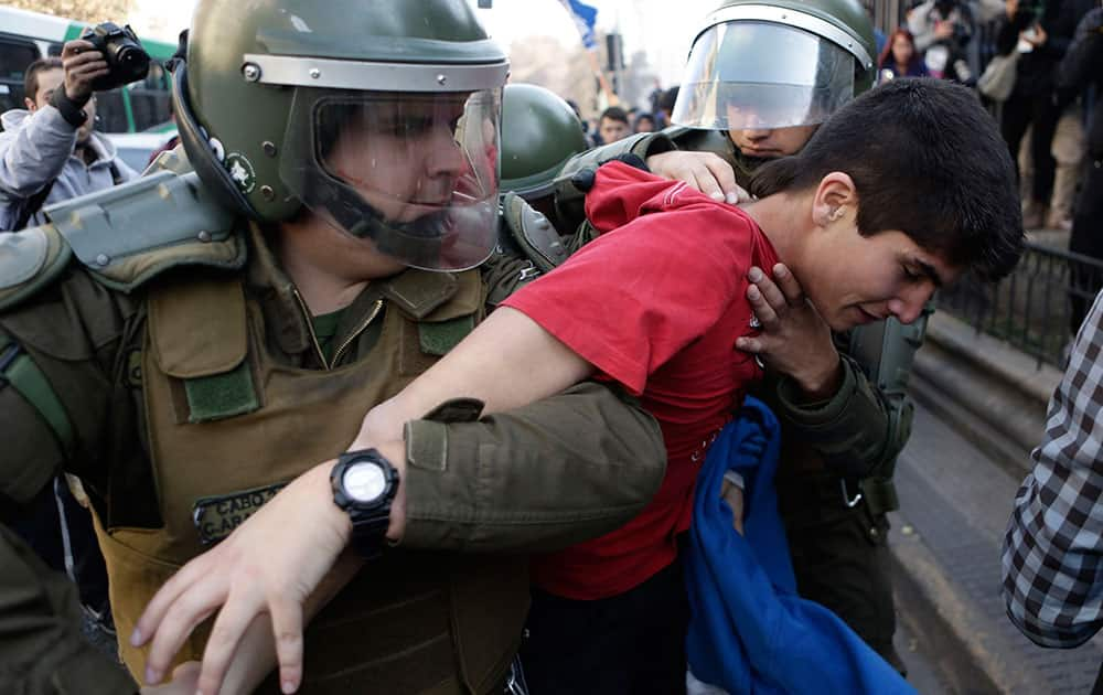 Police detain a demonstrator during a teachers' protest in Santiago, Chile.