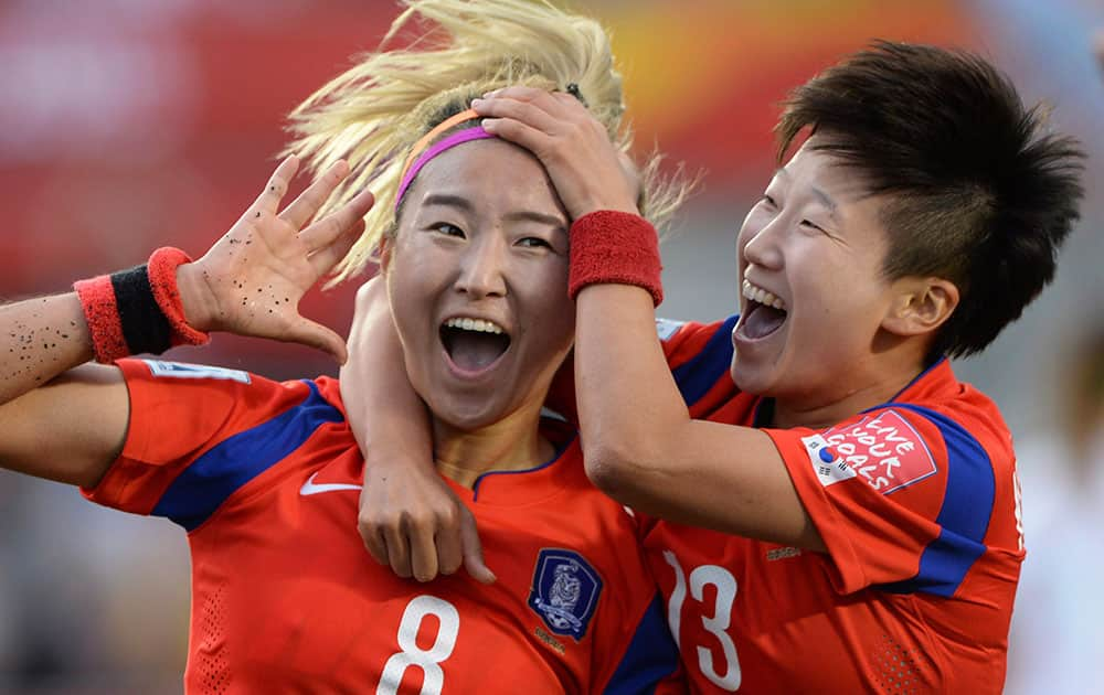 South Korea's Cho Sohyun (8) celebrates her goal with teammate Kwon Hahnul during the second half of a FIFA Women's World Cup soccer match, in Ottawa, Ontario, Canada.