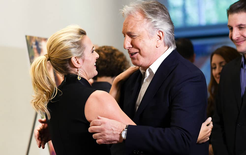 Actors Kate Winslet, left, and Alan Rickman greet each other at the premiere of 