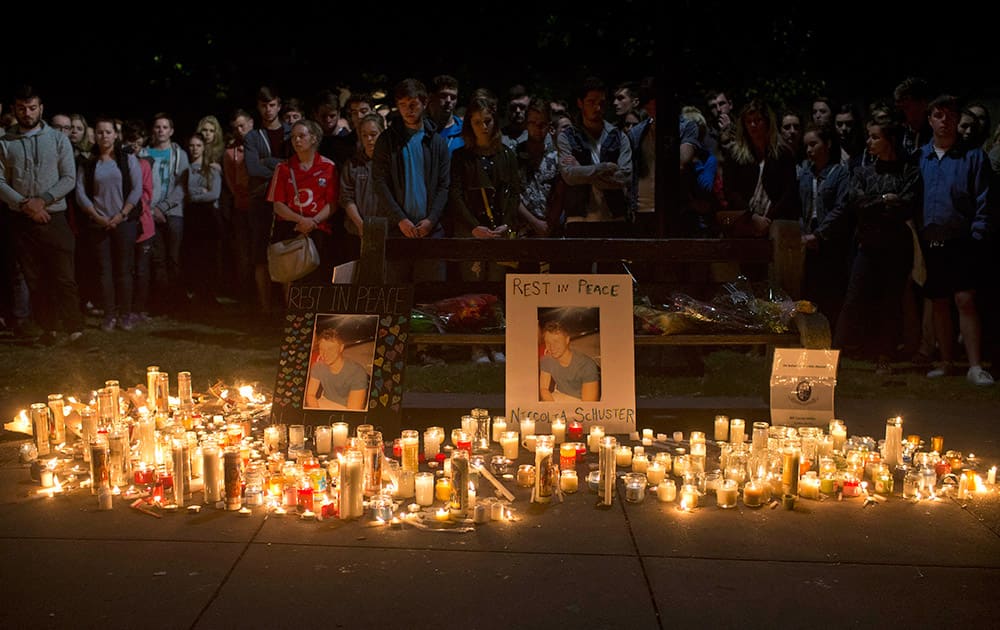 Mourners stand by during a candlelight vigil for six Irish students, in Berkeley, Calif. The six Irish students died when a balcony collapsed during a party.