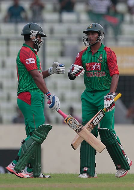 Bangladesh’s Tamim Iqbal celebrates with his teammate Soumya Sarkar after hitting to the boundary for four runs during the first one-day international cricket match against India in Dhaka, Bangladesh.