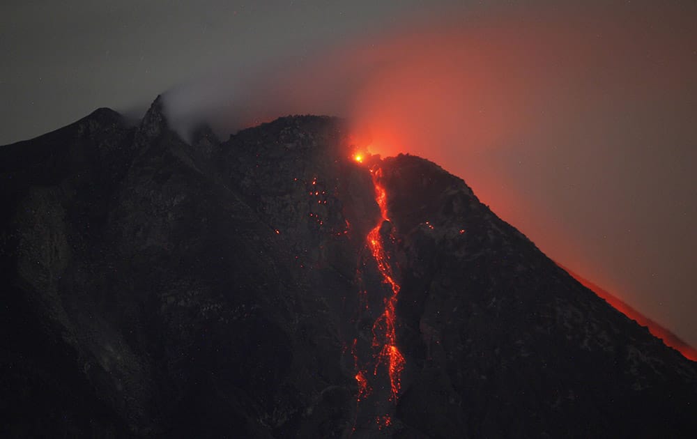 Hot lava flows from the crater of Mount Sinabung as seen from Tiga Pancur, North Sumatra, Indonesia.