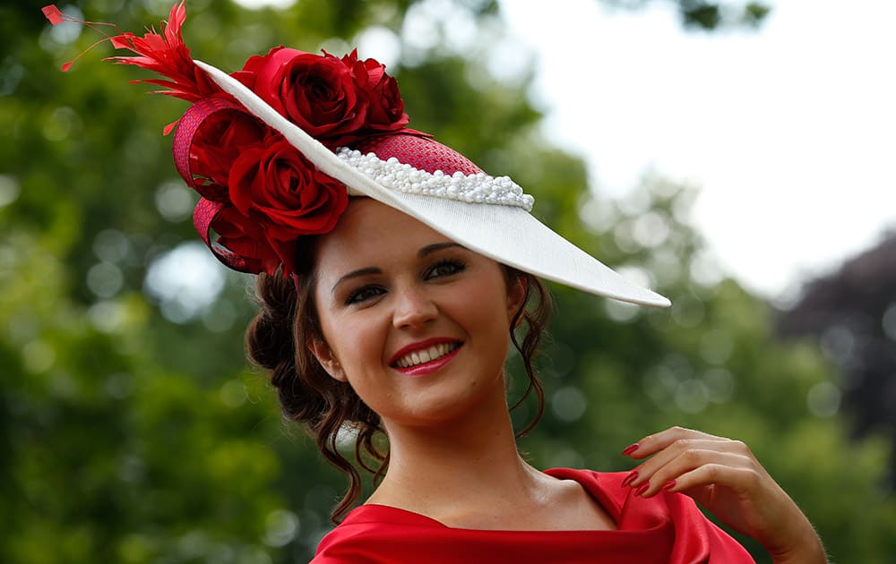 Jennifer Wrynne poses for photographers as she arrives for the third day of the Royal Ascot horse racing meet at Ascot, England.