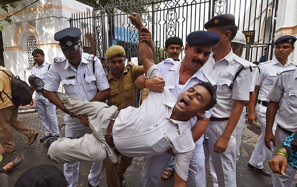 Police personal arrest Chit Fund sufferer during their protest aganist West Bengal Government in front of State Assembly in Kolkata.