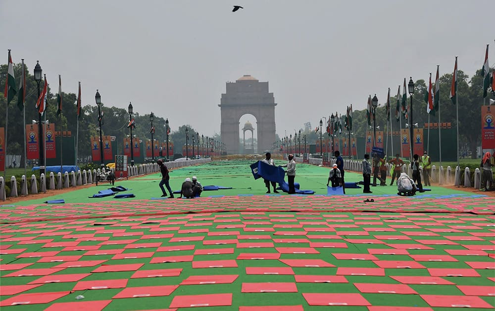 Workers during preparations for the upcoming Yoga Day celebrations at Raisina Hill in New Delhi.