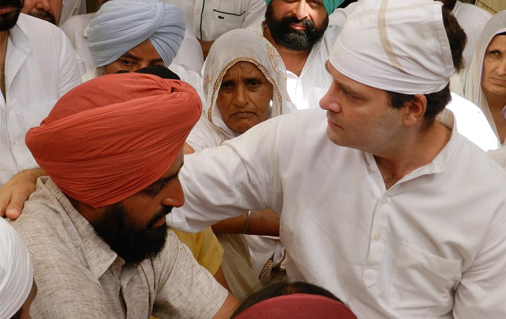 Congress Vice President Rahul Gandhi with the family of farmer Surjit Singh at village Dadumajra of district Fatehgarh Sahib in Punjab. Surjit Singh committed suicide last week. 