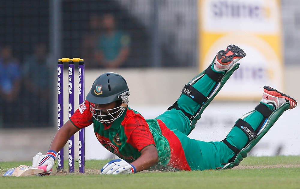 Bangladesh’s Tamim Iqbal dives to make his ground during the first one-day international cricket match against India in Dhaka, Bangladesh.