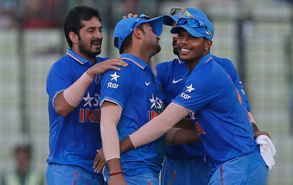 Teammates congratulate India’s Suresh Raina after the dismissal of Bangladesh’s Soumya Sarkar during the first one-day international cricket match in Dhaka, Bangladesh.