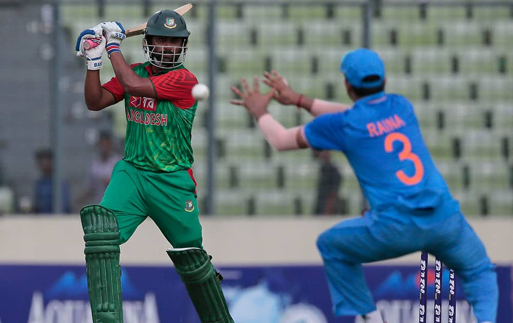 Bangladesh’s Tamim Iqbal, plays a shot, as India’s Suresh Raina attempts to field during their first one-day international cricket match in Dhaka, Bangladesh.