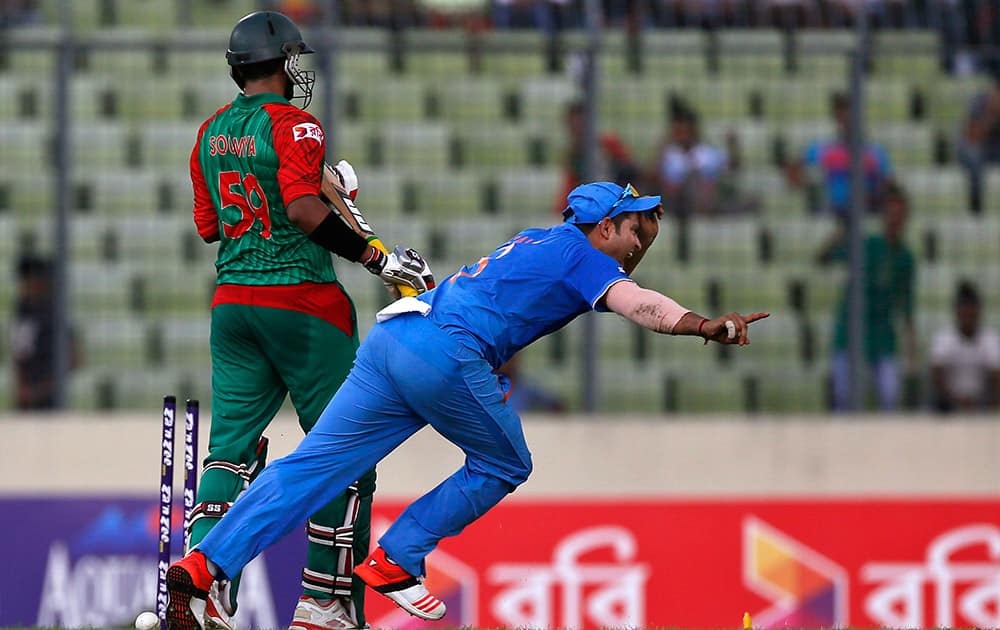 Suresh Raina, right, celebrates the dismissal of Bangladesh’s Soumya Sarkar during the first one-day international cricket match against Bangladesh in Dhaka, Bangladesh