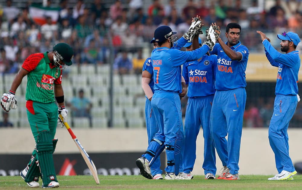 Ravichandran Ashwin, celebrate with teammates after the dismissal of Bangladesh’s Litton Das, left, during the first one-day international cricket match between them in Dhaka.