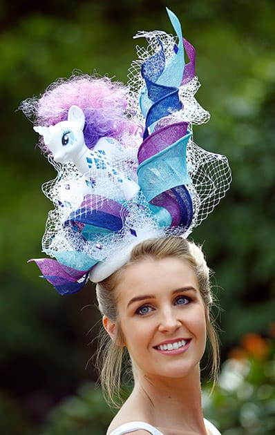 Grace Shaw poses for photographers as she arrives for the third day of the Royal Ascot horse racing meet at Ascot, England.