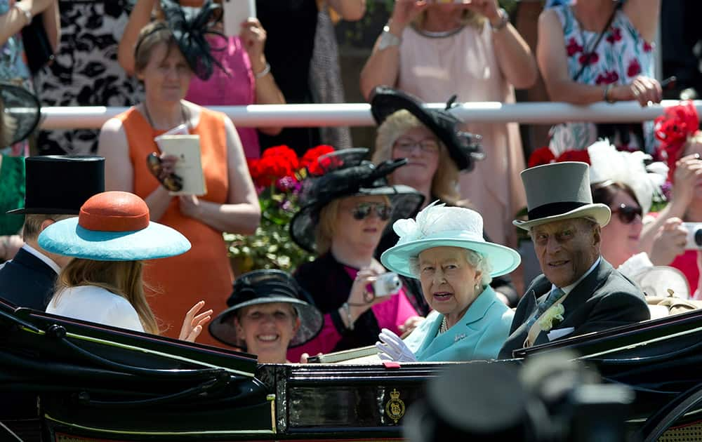 Britain's Queen Elizabeth II, with Prince Philip arrive in the parade ring on the third day of the Royal Ascot horse racing meet at Ascot, England.