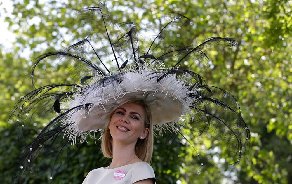 Anastasia Minerova poses for the media in an ornate hat on the third day of the Royal Ascot horse racing meet at Ascot, England.