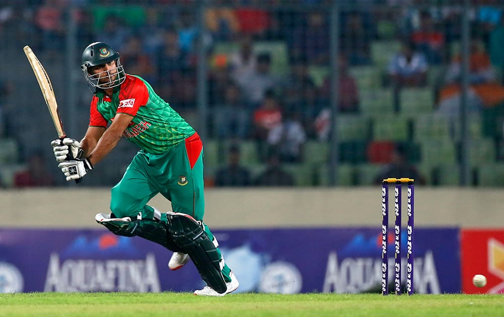 Mashrafe Mortaza plays a shot during the first one-day international cricket match against India in Dhaka, Bangladesh.