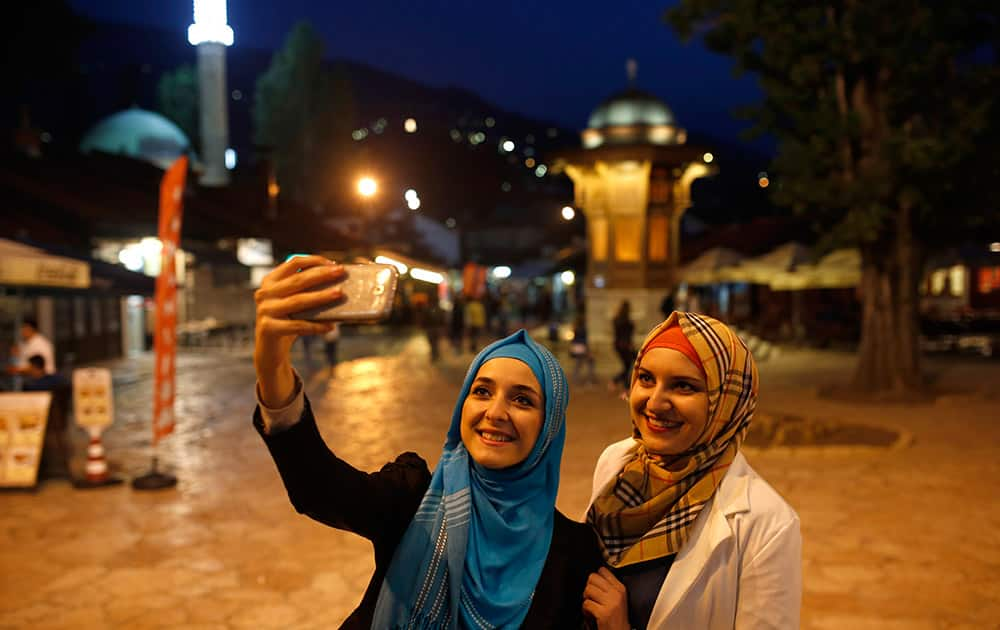 Bosnian Muslim girls walk in the old part of Sarajevo on the first day of the fasting month of Ramadan, in Sarajevo, Bosnia.