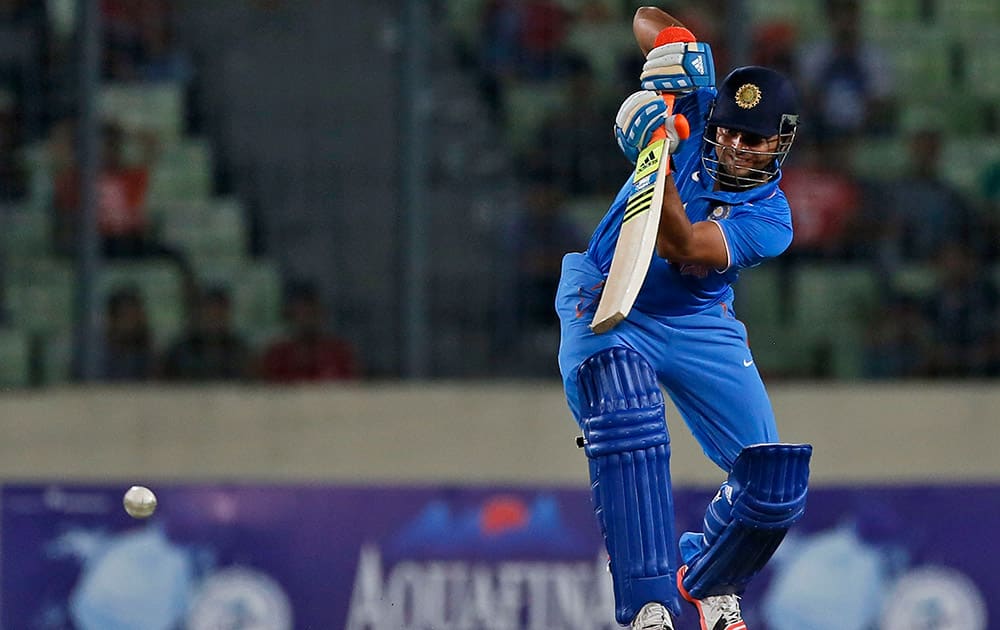 Suresh Raina plays a shot during the first one-day international cricket match against Bangladesh in Dhaka, Bangladesh.