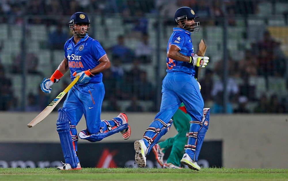 Ravindra Jadeja and Suresh Raina run between the wickets during the first one-day international cricket match against Bangladesh in Dhaka, Bangladesh.