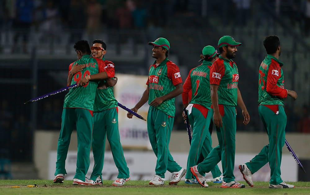 Bangladesh’s players celebrate their win over India during the first one-day international cricket match between them in Dhaka.