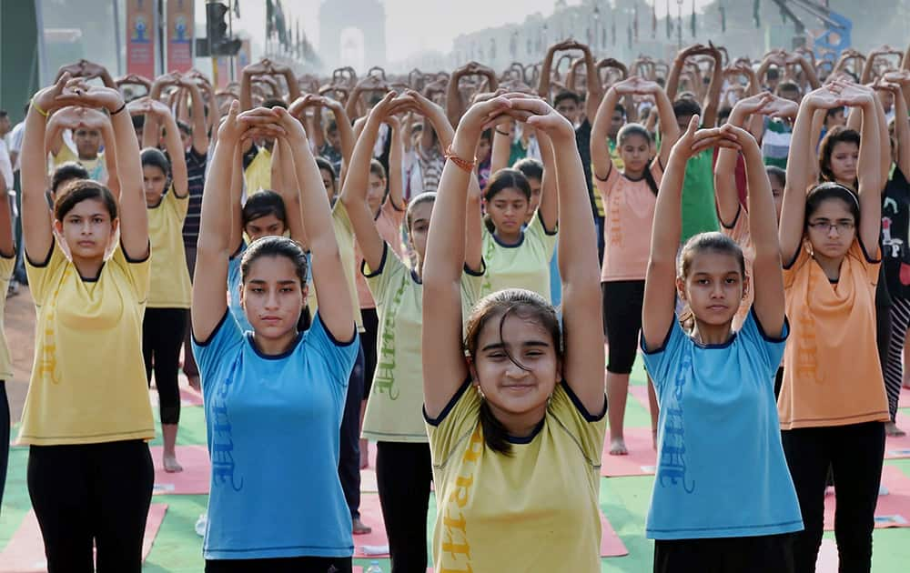 School children participate in a full dress rehearsal for International Yoga Day at Rajpath in New Delhi.