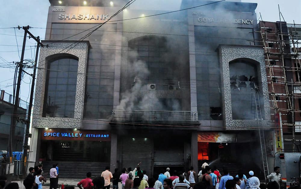 Smoke billows out after a major fire at a hotel in Pratapgarh.