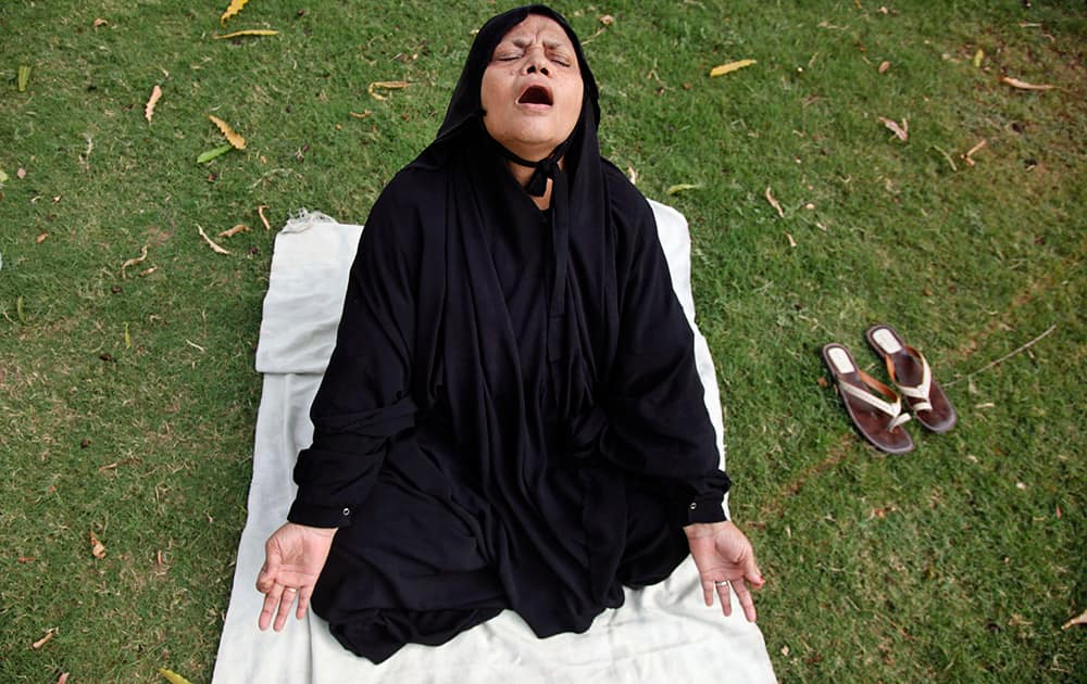 A Muslim woman performs Yoga exercises at a garden in Ahmadabad.