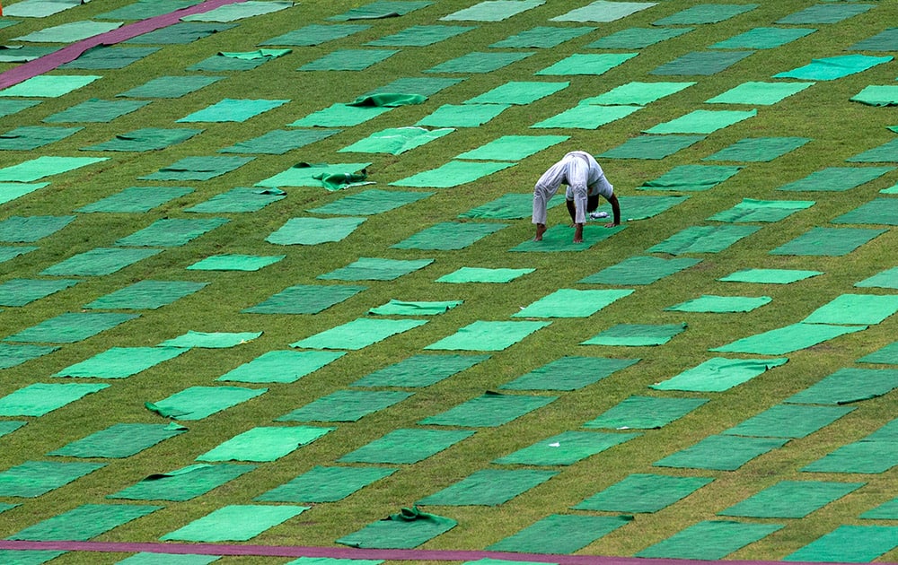 A man performs yoga in a stadium in New Delhi.