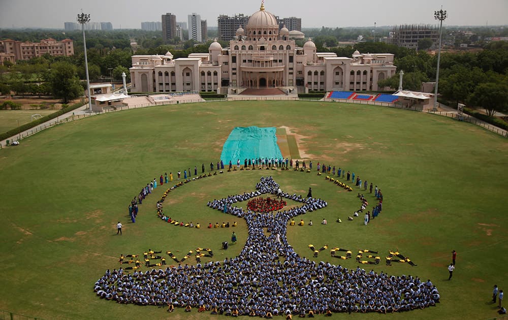 Students make a formation of the International Yoga Day symbol at a school in Ahmadabad. Sunday, June 21, marks the first International Yoga Day, which the government of Prime Minister Narendra Modi is marking with a massive outdoor New Delhi gathering.