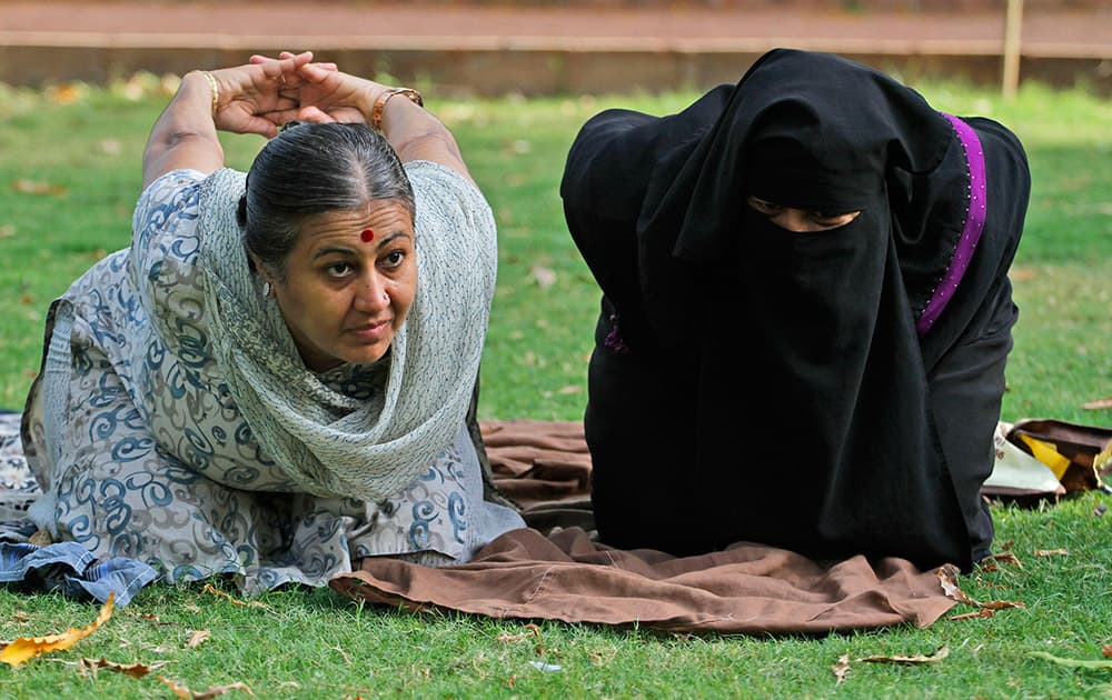 Yoga trainer Chandrikaben Kansara teaches yoga to a Muslim woman in a garden in Ahmadabad. Yoga has a long history India, reaching back for thousands of years. The government of Prime Minister Narendra Modi has made clear it wants the first International Yoga Day, held on Sunday, June 21, 2015, to be taken seriously.